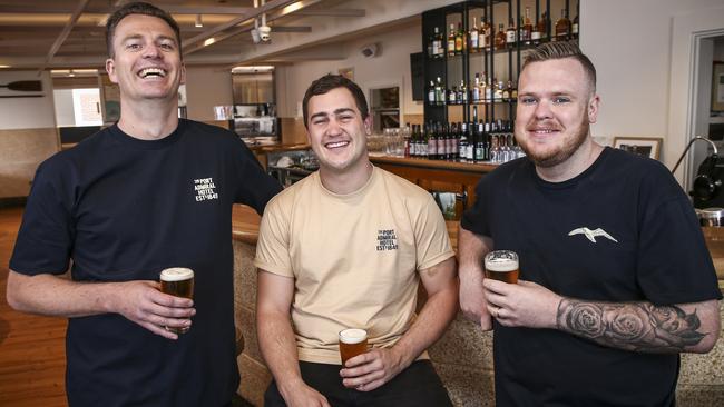 Port Admiral Hotel co-owners Crispian Fielke, Angus Henderson and Stewart Wesson in the front bar. Picture: AAP/Mike Burton