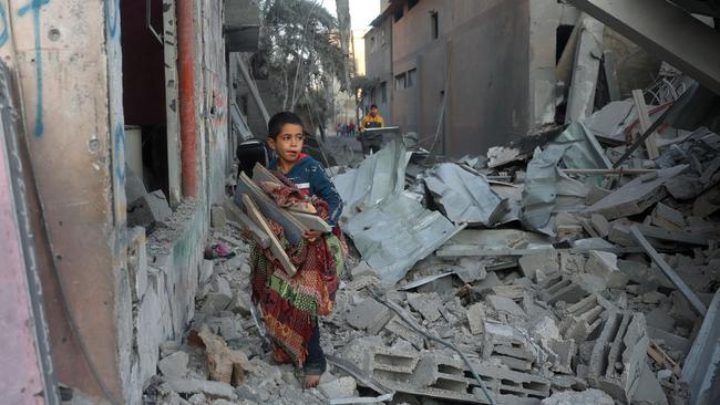 A Palestinian child salvages items in Nuseirat in the central Gaza Strip. Picture: AFP