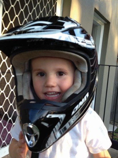 William plays with a bike helmet.