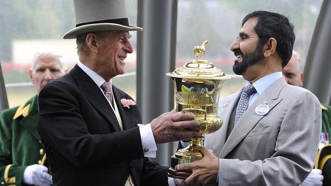 Prince Phillip presents Sheik Mohammed his trophy after Rewilding’s win in the 2011 Prince Of Wales Stakes. Picture: AP