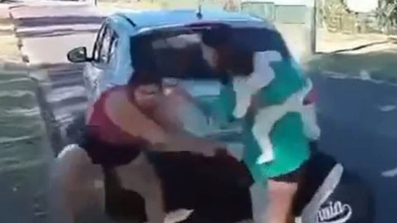 A mother steps in to break up a wild fight between two women throwing punches and pulling hair in outback Queensland. Picture: Supplied