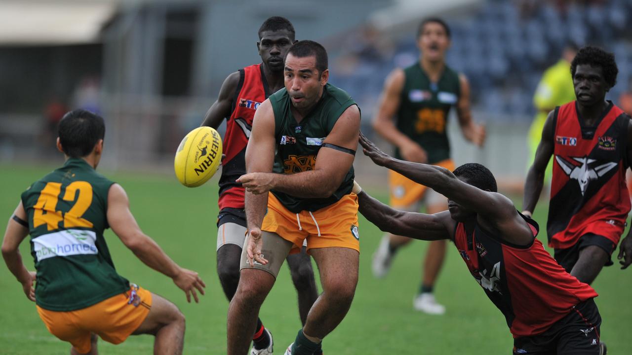 Anthony Vallejo (centre) of St Marys passes to team mate Josh Heath (left) while Guiseppe Tipiloura of Tiwi Bombers tries to stop during their TIO NTFL Premier League encounter at the TIO Stadium on Saturday.