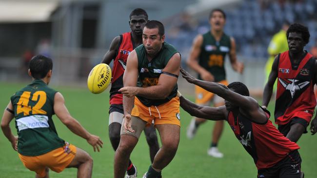 Anthony Vallejo (centre) of St Marys passes to team mate Josh Heath (left) while Guiseppe Tipiloura of Tiwi Bombers tries to stop during their TIO NTFL Premier League encounter at the TIO Stadium on Saturday.