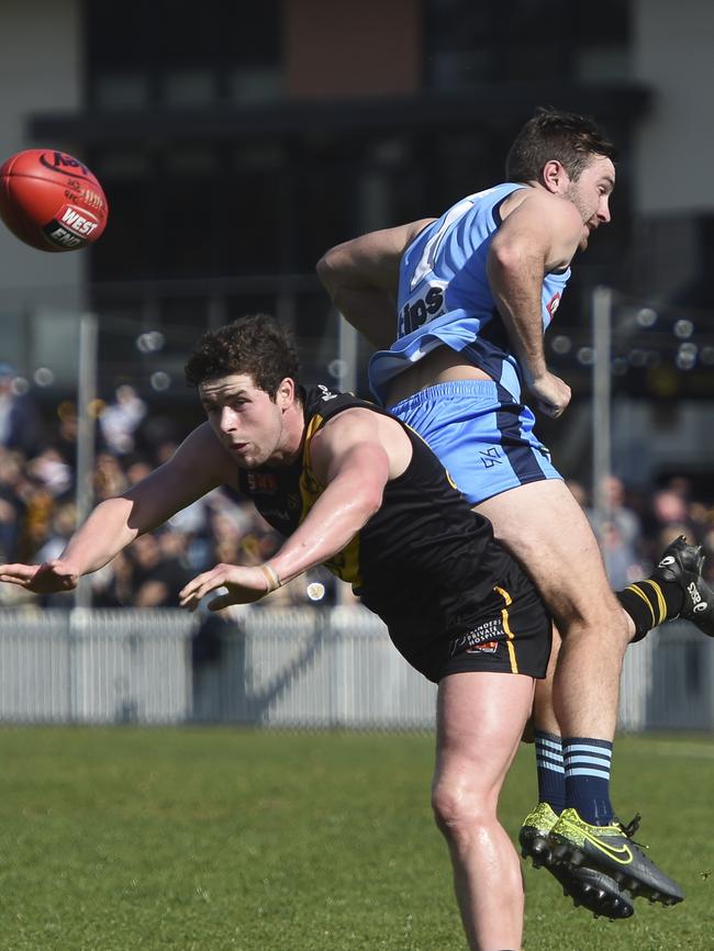 Sturt’s John Greenslade gets taken for a ride by Brad McCarthy. Picture: Naomi Jellicoe