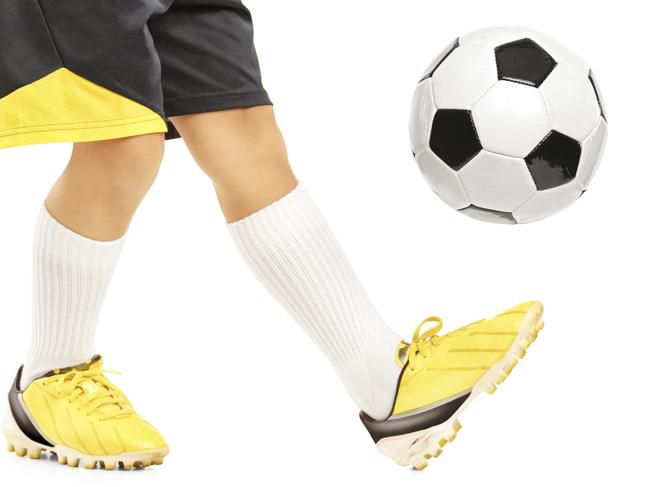 Townsville Families sport: Boy in sportswear joggling a soccer ball