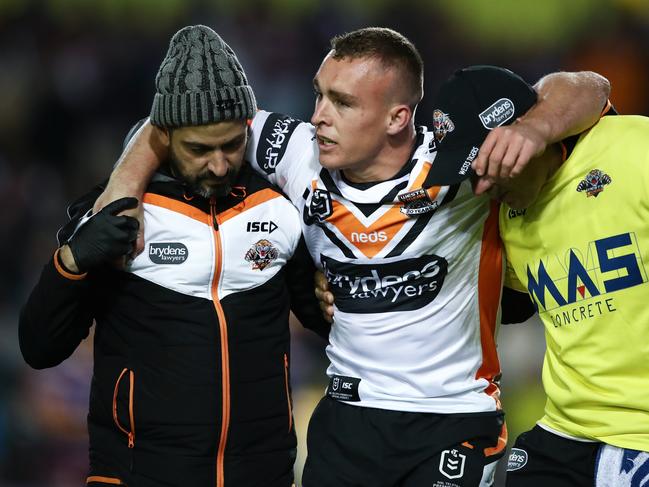 Jacob Liddle of the Tigers is helped from the field during the Round 22 NRL match between the Manly Sea Eagles and the Wests Tigers at Lottoland in Sydney, Thursday, August 15, 2019.  (AAP Image/Brendon Thorne) NO ARCHIVING, EDITORIAL USE ONLY