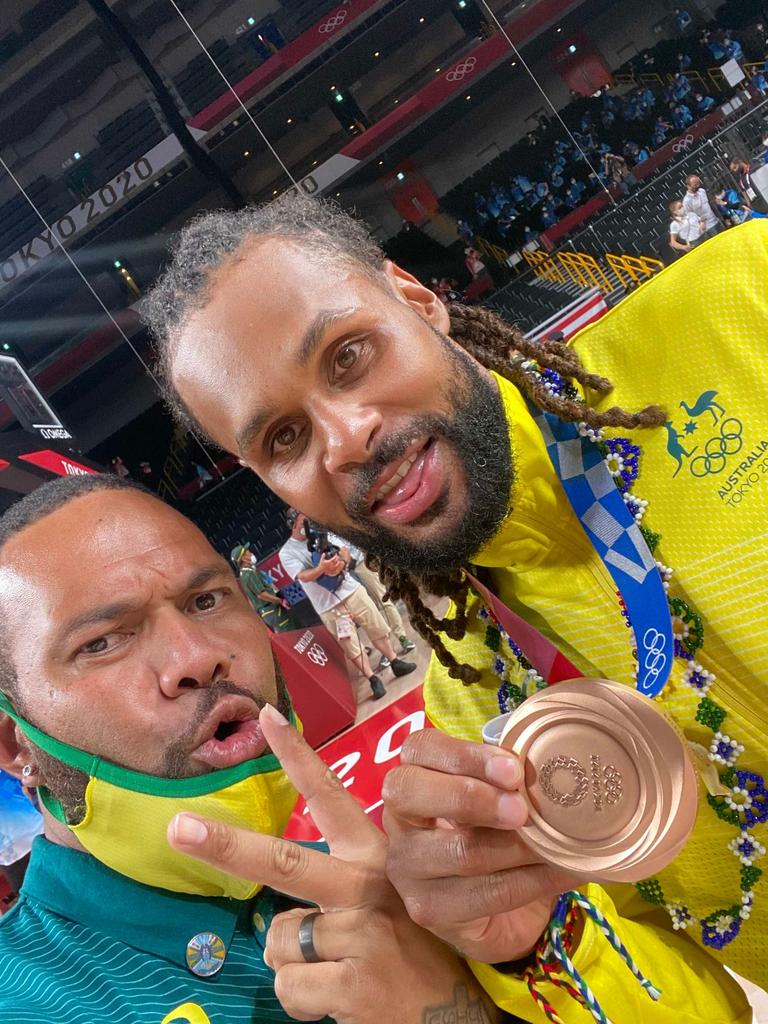 Boomers' team manager Junior Viranatuleo and Patty Mills celebrate the team's win over Slovenia to claim the bronze medal at the 2021 Tokyo Olympics.