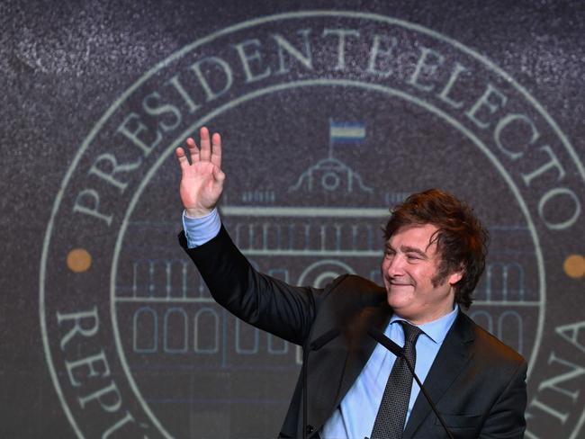 (FILES) Argentine presidential candidate for the La Libertad Avanza alliance Javier Milei waves to supporters after winning the presidential election runoff at his party headquarters in Buenos Aires on November 19, 2023. A visit on November 27-28, 2023, in New York to the grave of an ultra-Orthodox rabbi shows the peculiar spiritual journey of Argentina's president-elect, Javier Milei, between Catholicism and Judaism and no certainty of an eventual conversion. Milei, a 53-year-old ultra-liberal, has mentioned several times that he studies Torah. In the past, he has clearly defined himself as a Catholic and a believer in God. He has declared that somehow the natural and spontaneous order is "anarcho-capitalist", and that God is a "libertarian", as he is. (Photo by Luis ROBAYO / AFP)