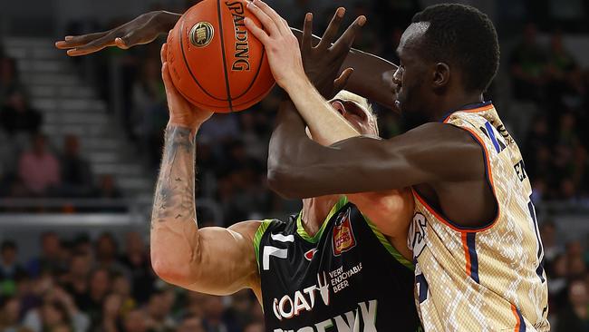 Mitchell Creek of the Phoenix is fouled by Majok Deng of the Taipans during the round two NBL match between Phoenix and Taipans. (Photo by Daniel Pockett/Getty Images)