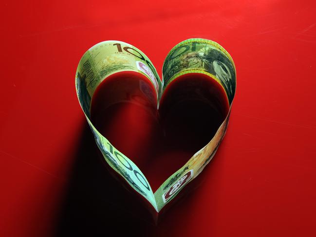 STM Generic shot for Love Rat story. Love heart shape of money hundred buck dollar bills red background rip off scam REPORT Bill Rule  PIC Karin Calvert