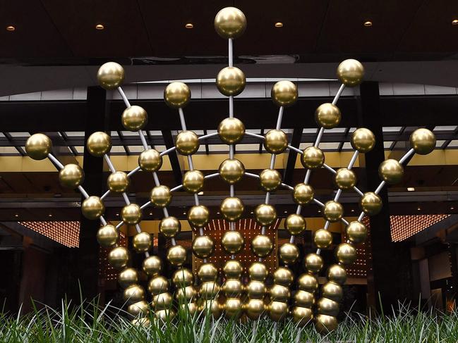 Signage adorns the side of the Crown Casino in Melbourne on March 22, 2021 after Crown Resorts received a takeover bid from US investment manager Blackstone just weeks after being denied a licence to run a multi-billion-dollar Sydney casino, the Australian gaming group said (Photo by William WEST / AFP)