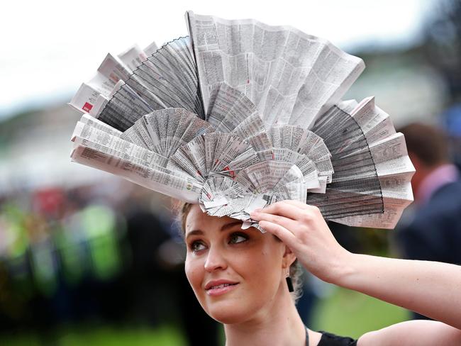 2014 AAMI Victoria Derby Day, Flemington, Victoria. Elizabeth Lewis, 27, from Brisbane, with her newspaper hat. Picture: Mark Stewart