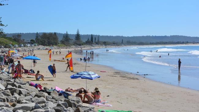 Summer fun: People enjoying the sunshine at Brooms Head on the beach.