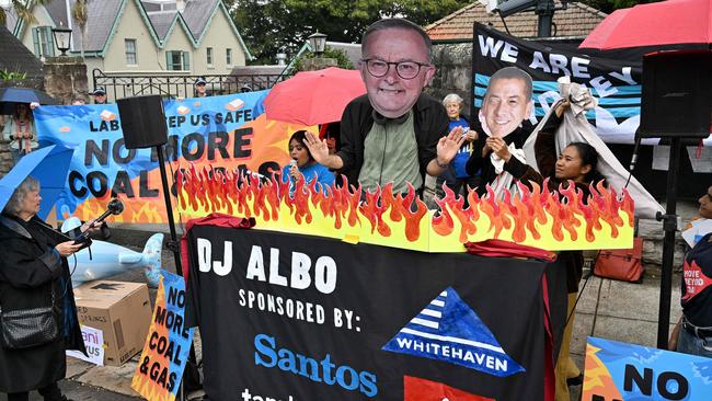 An environmental activist wearing a cardboard cutout showing the face of Prime Minister Anthony Albanese is seen during a protest rally in front of Kirribilli House, in Sydney, on May 8, calling for the Albanese government to halt further approvals of coal and gas projects. Picture: Saeed KHAN / AFP