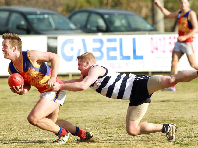 Mulgrave’s Darren Butler looks to slip a Troy Hill tackle Picture: Janine Eastgate