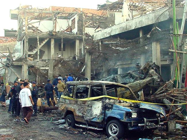 Forensic police among the wreckage after the Bali bombings which killed 88 Australians.