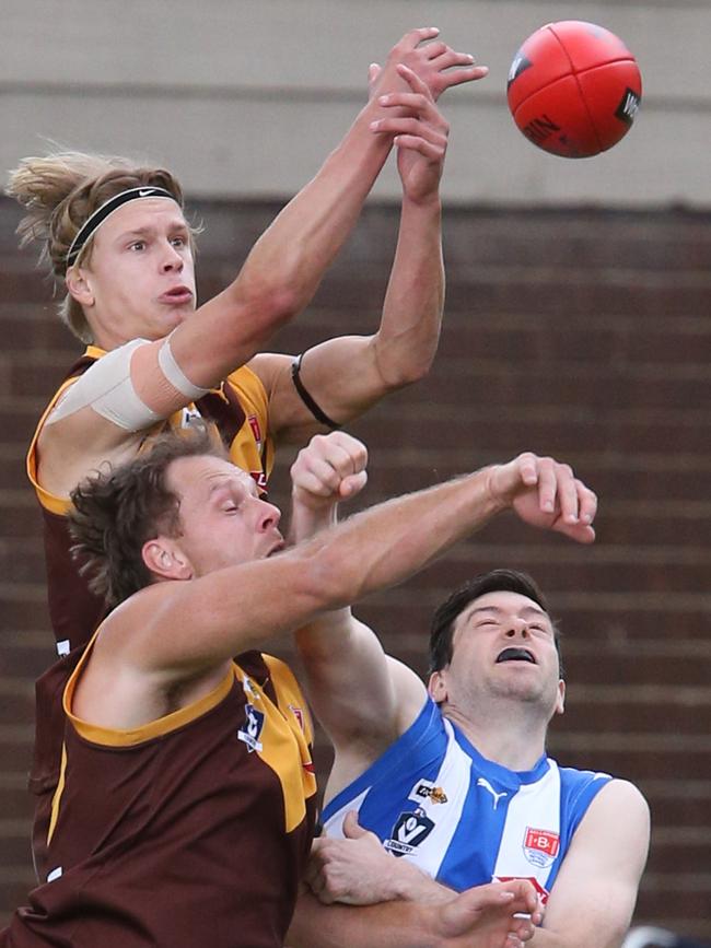 A leaping Luke Preece attempts to mark over Jye Hawkins and Anglesea’s Ash Caldwell. Picture: Mark Wilson