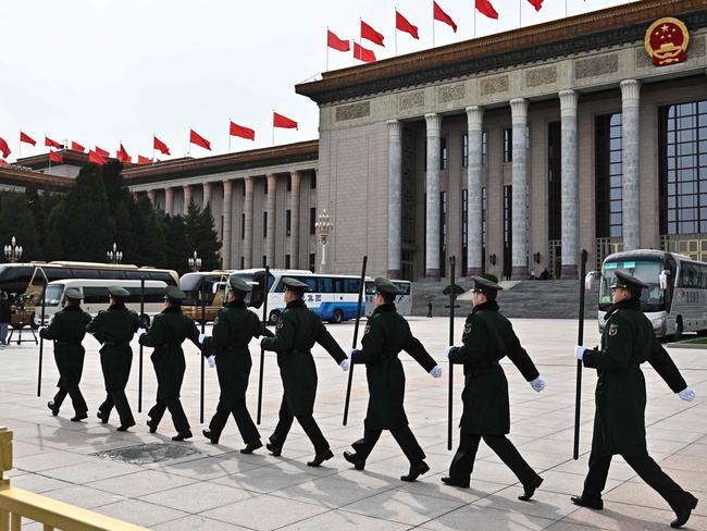 Chinese People's Liberation Army (PLA) soldiers are seen outside the Great Hall of the People in Beijing on March 3, 2025, ahead of the country's annual legislative meetings known as the "Two Sessions". (Photo by Pedro Pardo / AFP)