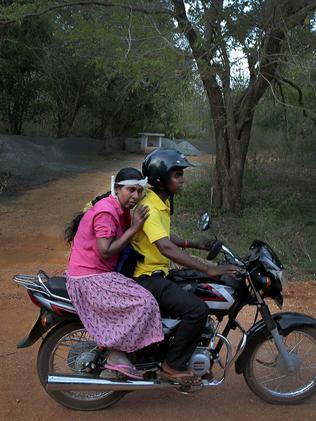V.G. Karunawathie, left, rides home after getting dialysis treatment. Picture: AP Photo/Eranga Jayawardena.