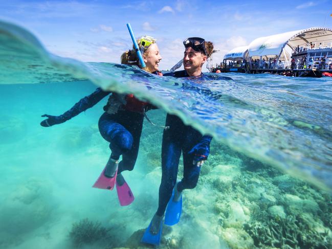 Nicola Beverley and Craig Walker from Sydney tick off a bucket list adventure after snorkelling on The Great Barrier Reef in the Whitsundays. Picture: Lachie Millard