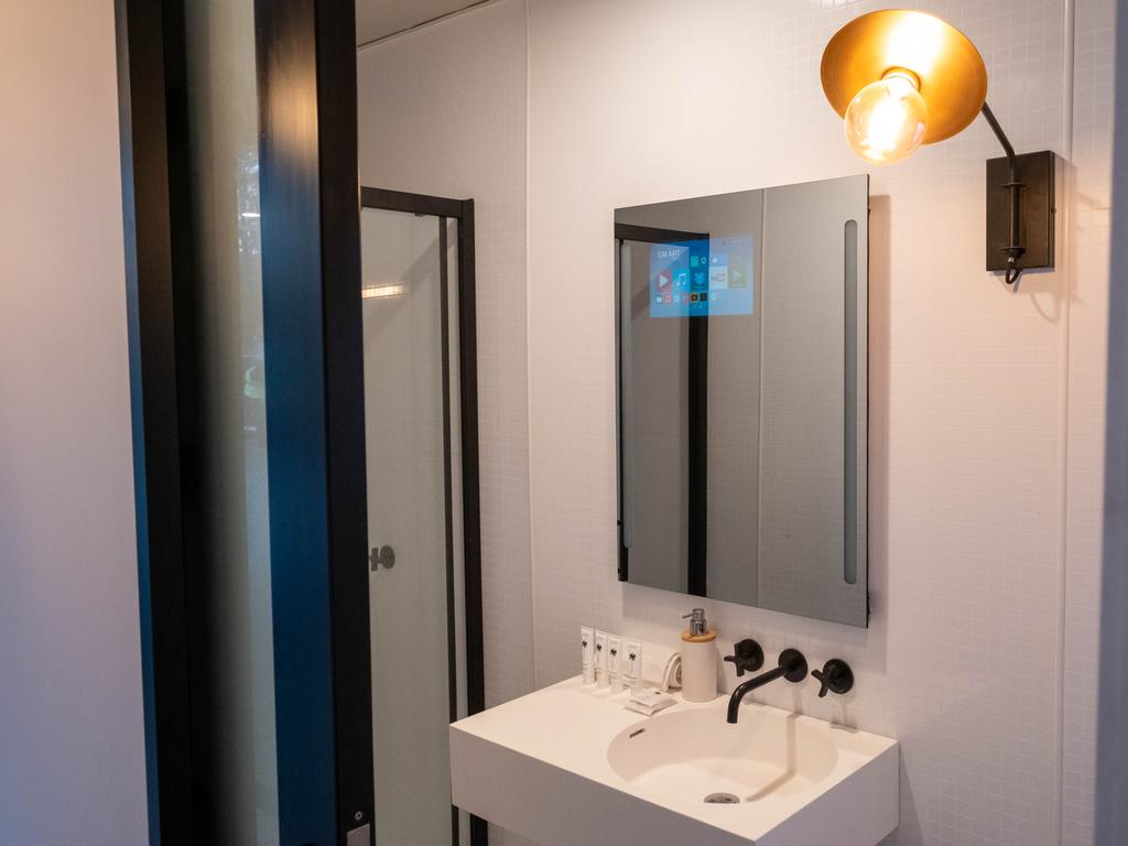 The bathroom has its own ‘Smart Mirror’ powered by a phone.