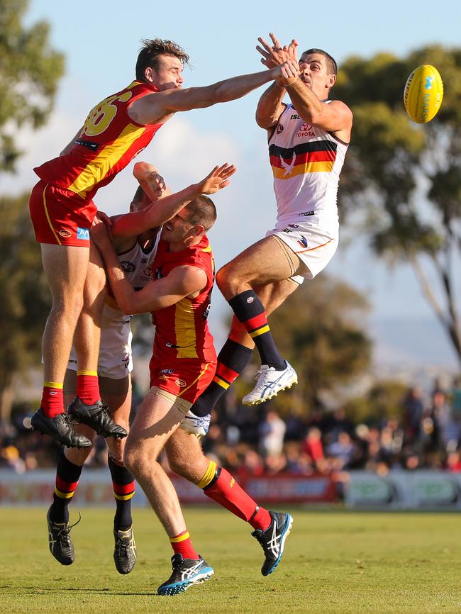 Taylor Walker and Reilly O'Brien of the Crows fly with Caleb Graham and Zac Smith of the Suns during the 2020 Marsh Community Series match between the Adelaide Crows and the Gold Coast Suns at Flinders University Stadium on March 06, 2020 in Adelaide, Australia. (Photo by AFL Photos)