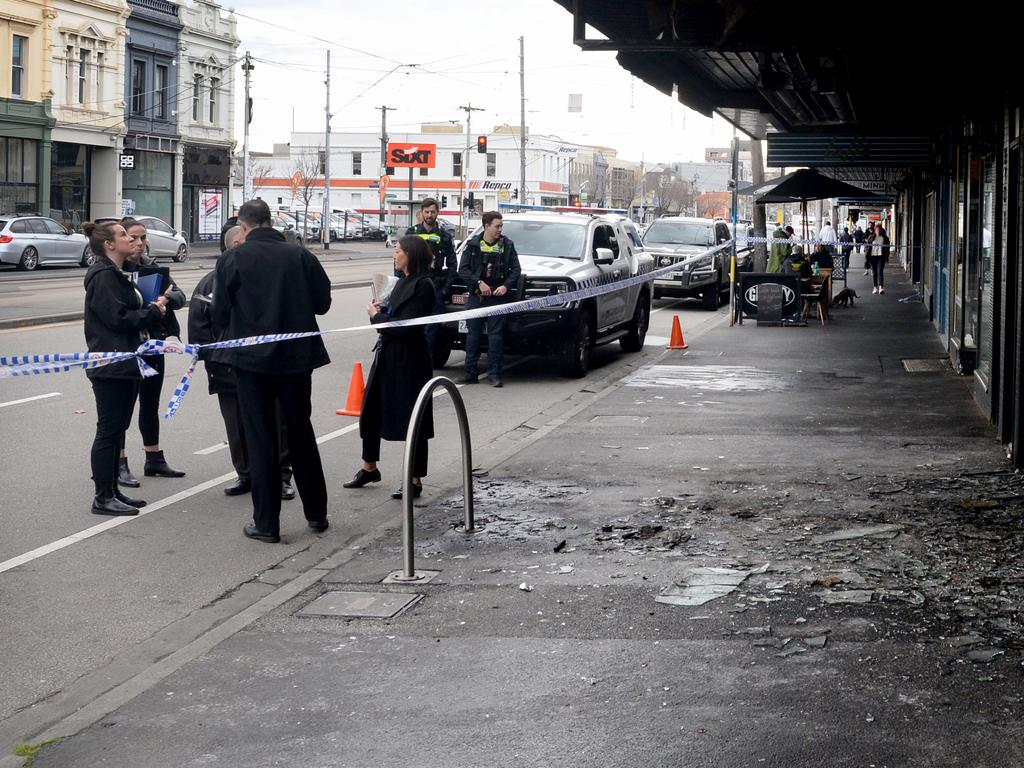 Shattered glass litters the footpath after the attack. Picture: Andrew Henshaw