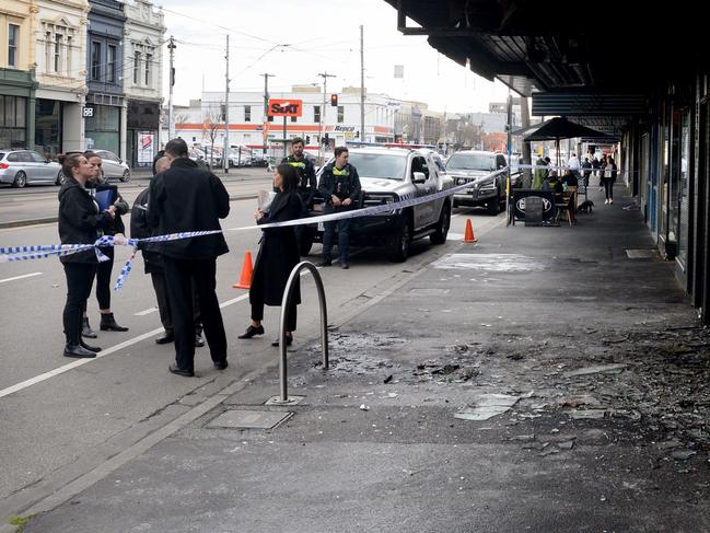 Shattered glass litters the footpath after the attack. Picture: Andrew Henshaw