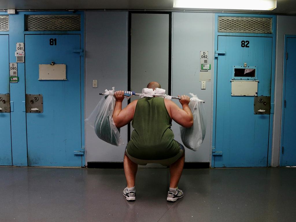 A prisoner does a weight session with two plastic bags inside Darcy 2 compound in D Block. Picture: Adam Taylor