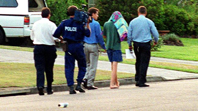 SLD (under a towel) with police after the murder of Courtney Morley-Clarke in 2001.