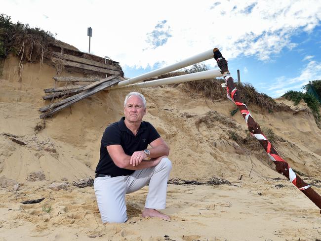 Peninsula Chamber President Matthew Wales in 2017 near exposed Optus cable on Ocean Beach in Umina, caused by months of dune erosion. Picture: Troy Snook