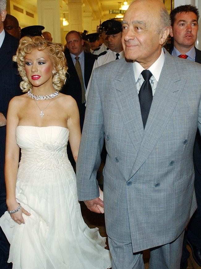 Christina Aguilera holds the hand of Mohammed al-Fayed, during a tour of Harrods. Picture: AP.