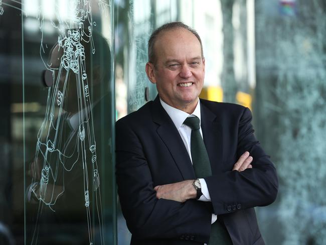 07/02/2019. Adrian Collette, newly appointed chief executive of the Australia Council for the Arts. Photographed at their offices in Surry Hills, Sydney. Artwork in background on window by Gosia Wlodarczak, Frost and shadow drawing for the Australia Council. Britta Campion / The Australian