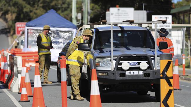 Australian Defence Force personnel assist Queensland police at the Miles St checkpoint. Picture: Scott Powick.