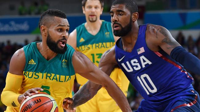 Australia's guard Patty Mills (L) tries to pass USA's guard Kyrie Irving during a Men's round Group A basketball match between Australia and USA at the Carioca Arena 1 in Rio de Janeiro on August 10, 2016 during the Rio 2016 Olympic Games.