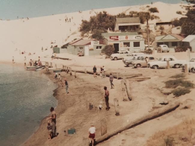 Children slide down the sandhills beside the Onkaparinga River, at Port Noarlunga, in 1972. Picture: Pene O’Dea