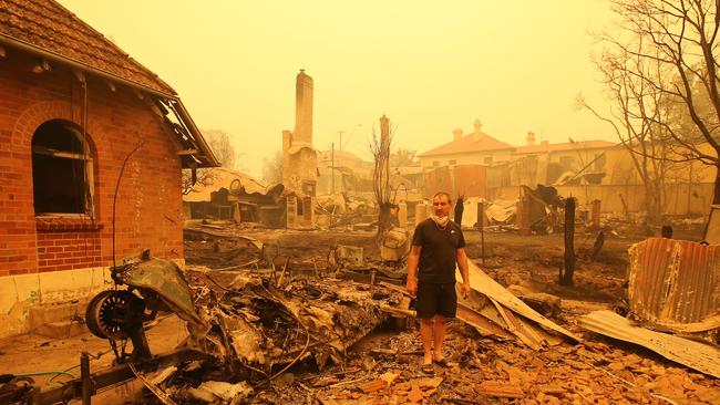 Gary Hinton amongst the debris of his home in Cobargo.Picture: Stuart McEvoy.