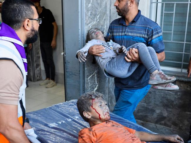 Emergency responders bring wounded children at al-Shifa hospital following Israeli strikes in Gaza City. Picture: AFP