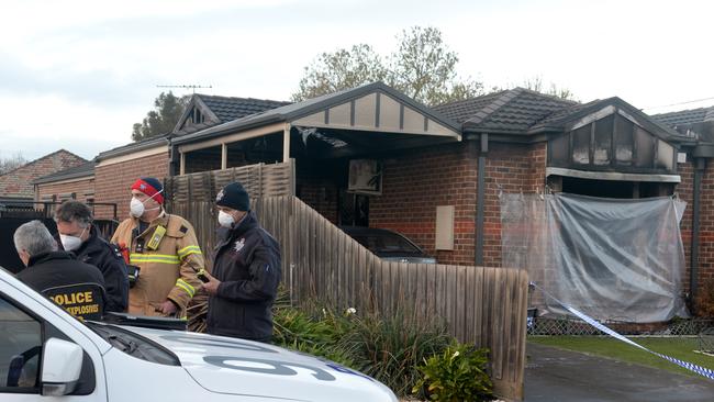 Police and fire investigators at the scene of a fatal house fire. Picture: Andrew Henshaw