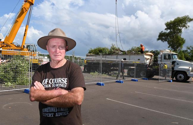 Independent MLA Gerry Wood stands in front of the milkwood tree that was cut down at the CDU development site in the Darwin CBD. Picture: KATRINA BRIDGEFORD