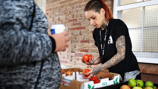 Laura Palozzi helps a client with her shopping at Baulkham Hills last Friday. Pictures: Angelo Velardo)