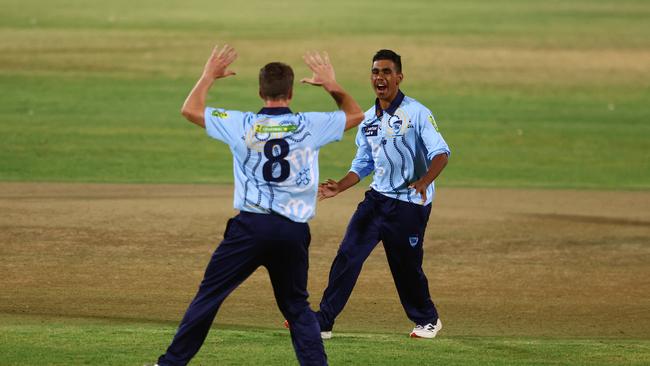 Les Smith (right) celebrates a wicket.