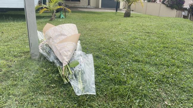 Floral tributes at the home of killed Gold Coast woman Kelly Wilkinson.