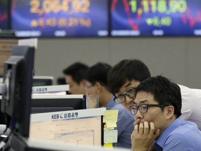Currency traders watch markets in Seoul, South Korea. There is real fear the crisis could send shock waves through financial markets around the world. Picture: AP Photo/Ahn Young-joon.