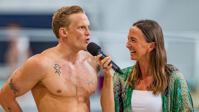 Cody Simpson speaks to Olympian Brooke Hanson after his win in the 100m butterfly at the Queensland State championships.