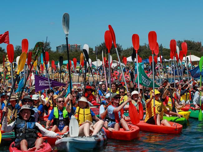 NEWCASTLE, AUSTRALIA - NOVEMBER 26: People take to the water as they continue blockade the access to the coal port in protest for climate action at Horseshoe Beach on November 26, 2023 in Newcastle, Australia. The group organising the protest said in a Facebook post that they aim to hold the largest peaceful civil disobedience protest for climate action in Australia's history, at the world's largest coal port at Newcastle.  Australia is still one of the world's most prolific consumers and producers of coal, an ongoing point of contention as the country tries to pivot to meet emissions reduction targets. (Photo by Roni Bintang/Getty Images)