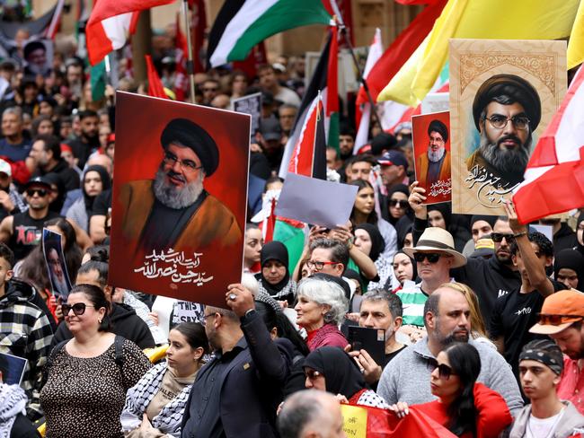 Demonstrators hold up pictures of Hezbollah leader Hassan Nasrallah at a protest at Town Hall in Sydney. Picture: NewsWire / Damian Shaw