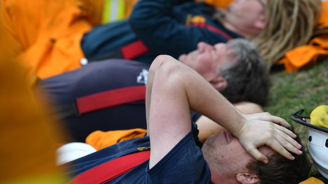 A fire fighter resting at Kingscote oval after fighting fires through the night, on Kangaroo Island. Photo: David Mariuz / AAP Imag.