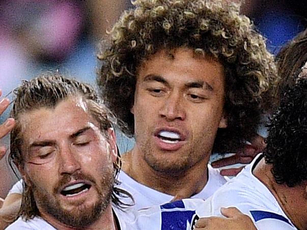 Corey Harawira-Naera of the Bulldogs (centre) celebrates with teammates after scoring a try during the Round 22 NRL match between the South Sydney Rabbitohs and the Canterbury Bulldogs at ANZ Stadium in Sydney, Saturday, August 17, 2019. (AAP Image/Dan Himbrechts) NO ARCHIVING, EDITORIAL USE ONLY