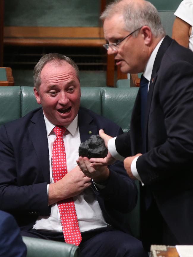 Treasurer Scott Morrison hands Deputy PM Barnaby Joyce and a lump of coal during Question Time. Picture: Kym Smith